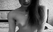 Look at this cute petite brunette with tattoos dancing naked in socks on her bed, teasing us