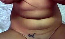 Cute brunette teases shaved pussy with dildo.