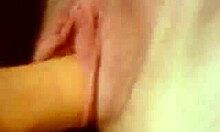 Aroused girlfriend spreads shaved pussy for close-up dildo masturbation in homemade clip.