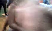 Russian blonde amateur strips naked outdoors, dancing with big natural tits and tan lines visible.