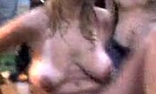 Russian blonde amateur strips naked outdoors, dancing with big natural tits and tan lines visible.