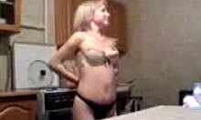 Blond MILF feels excited stripping naked in the kitchen for the camera