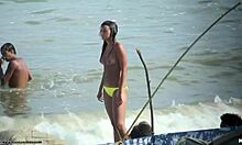 Ever seen a topless beauty at a nudist beach? This brunette flaunts her breasts openly.