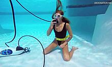 Katya Nakolkina swims underwater in the pool as a brunette babe