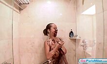 Teen Paris Milan spreads chocolate over body in shower.