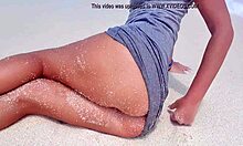 blonde feels pleasure masturbating on sandy beach