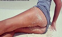blonde feels pleasure masturbating on sandy beach