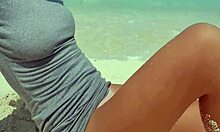 blonde feels pleasure masturbating on sandy beach