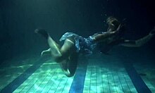 Russian brunette with big tits bounces underwater in the pool, showing her pussy