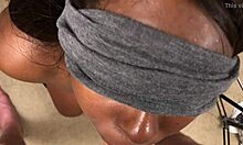 The blindfolded black teen eagerly sucks the white cock before receiving a facial