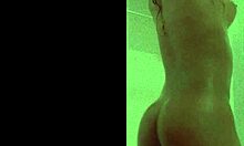 Davina bathes in shower with ebony skin wet and glistening softly