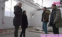 German couple engages in public group sex with swingers in abandoned location.