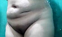 my busty stepmother fingers herself while bathing, looking so hot and tempting