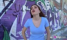 Flawless brunette babe mini vamp engages in intense public deepthroat blowjob and exhibitionism with big tits on display.