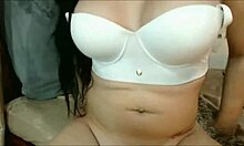 dark-haired hottie blows cock while chatting on the phone.