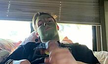 Fit guy strokes his cock during skin care routine