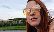 A fiery redhead tempts with her curves and tattoos