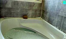 Amateur milf wife soaks in the bath, showing her shaved pussy