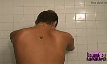 Sexy short-haired brunette shaves her legs in the shower.