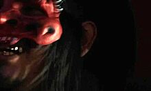 A scared teen was taken by a fierce milf. She used a huge black dildo to dominate.