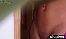 A curly ebony teen with big ass poses naked, her amazing body undressing intensely.