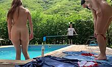 Natasha and Megan tan naked while the lucky guy cleans pool.