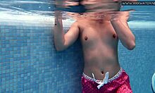 Cute shy Czech teen Lady Dee swimming in pool.