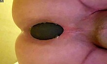 An amateur woman has anal sex with a big plug - couple amateur