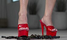 Petite brunette crushes fruits with bare feet