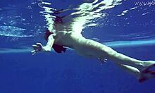 Watch Lina Mercury in red lingerie underwater, showcasing her big tits and tight pussy