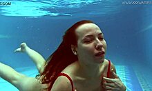 Watch Lina Mercury in red lingerie underwater, showcasing her big tits and tight pussy