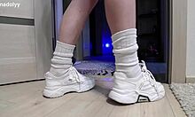 Delicate legs in sneakers wait eagerly for attention