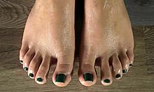 Cleaning her FEETS with a damp cloth and showing her green FEET fingernails CLOSE UP