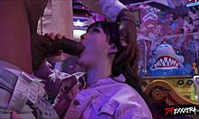 Blonde teen gets fucked doggystyle by big black cock in arcade.