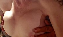 Cougar wife teases tits with sensual handjob.