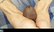 Naughty brunette gives footjob