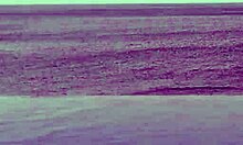 beautiful skinny asian college girl with ponytail relaxing at infinity pool