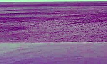 beautiful skinny asian college girl with ponytail relaxing at infinity pool