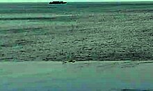 beautiful skinny asian college girl with ponytail relaxing at infinity pool