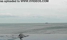 beautiful skinny asian college girl with ponytail relaxing at infinity pool