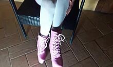 Latina milf sits on chair in pantyhose and high heeled boots, looking sexy