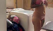 neighbor watches woman wash clothes outdoors freely