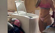 neighbor watches woman wash clothes outdoors freely