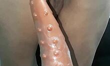 Blonde latina sits on giant