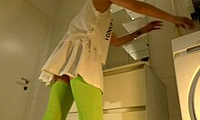 Brunette shows panties under mini skirt in bathroom