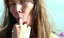 Beach babe Juliette fingers her tight cunt to a hard cum on the sand