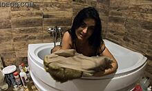 Milfy Calla indulges in pee play in the bathtub wearing fur coat and pantyhose