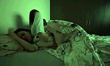 Lesbians snuggle in bed, touching asses passionately