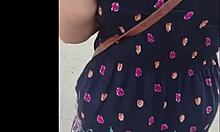 Following a mature woman on the street with skirt and thong