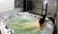 A young lesbian couple relaxes in the bath, their fingers exploring each other's wet pussies intimately.